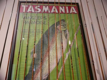 A tasmanian fishing poster hanging on a wall.