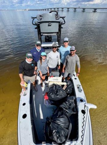A group of people on a boat posing for a photo.