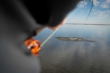 A person is fishing in a body of water.