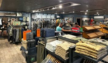 The inside of a clothing store with a lot of clothes.