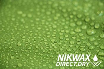 Water droplets on a green surface with the words nikwax direct dry.