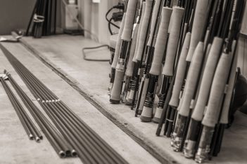 A black and white photo of a group of fishing rods.