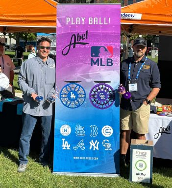 A group of people standing in front of a tent.