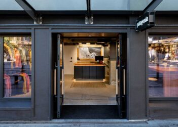 The entrance to a store with a black door.