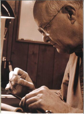 A man is working on a piece of paper.