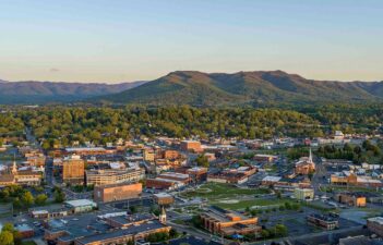 An aerial view of a city with mountains in the background.