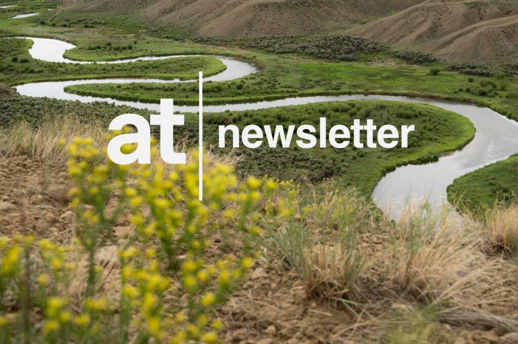 A winding river flows through a green valley with hills in the background; "at newsletter" text is overlaid on the image.
