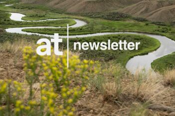 A winding river flows through a green valley with hills in the background; "at newsletter" text is overlaid on the image.