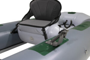 A close-up of an inflatable boat featuring a padded seat with a backrest and a mounted fishing rod holder on the side.
